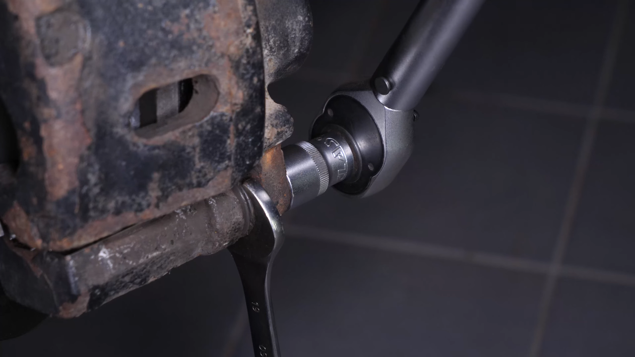 Put the brake caliper back