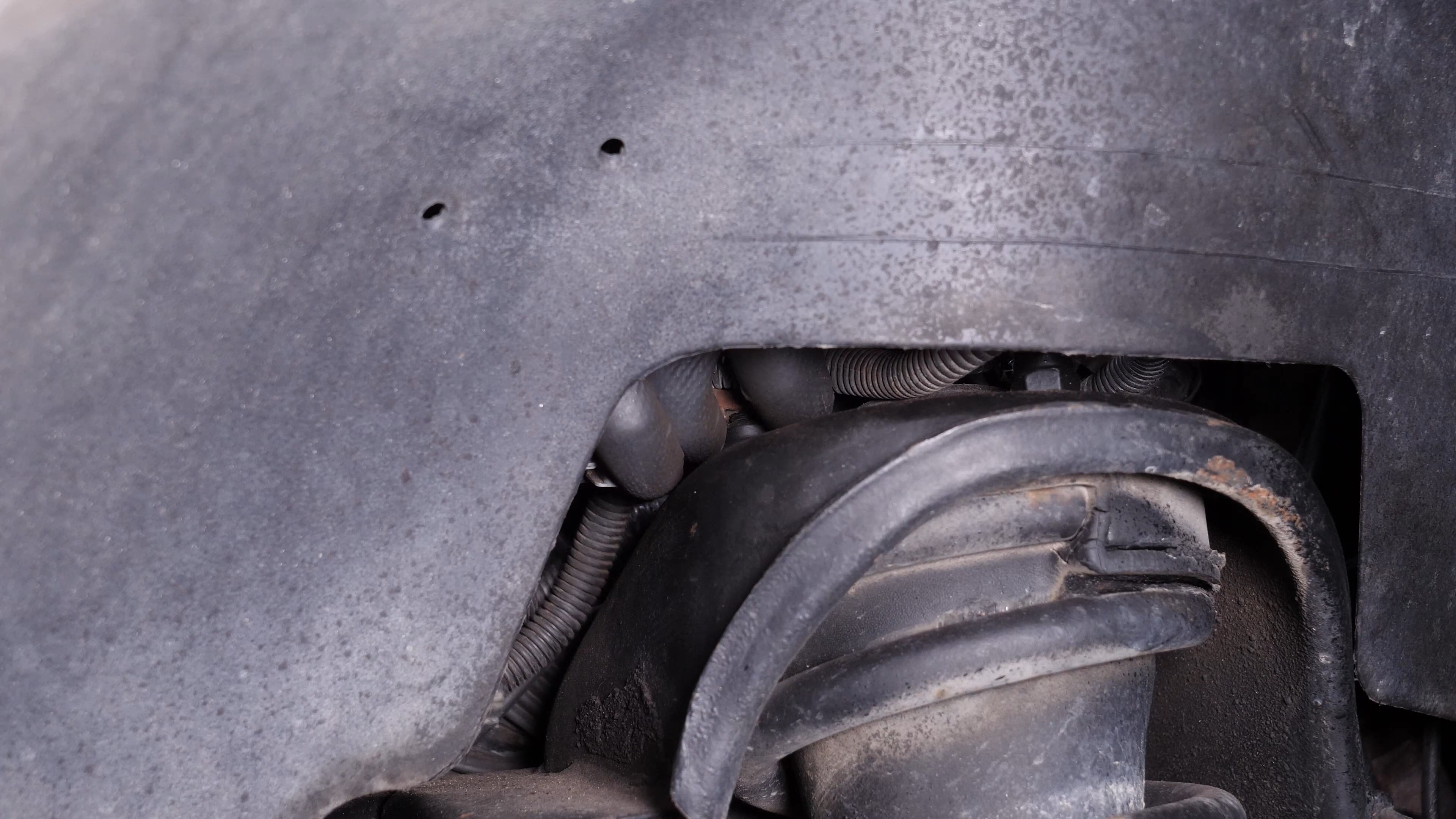 Unscrew the strut mount bearing nuts
