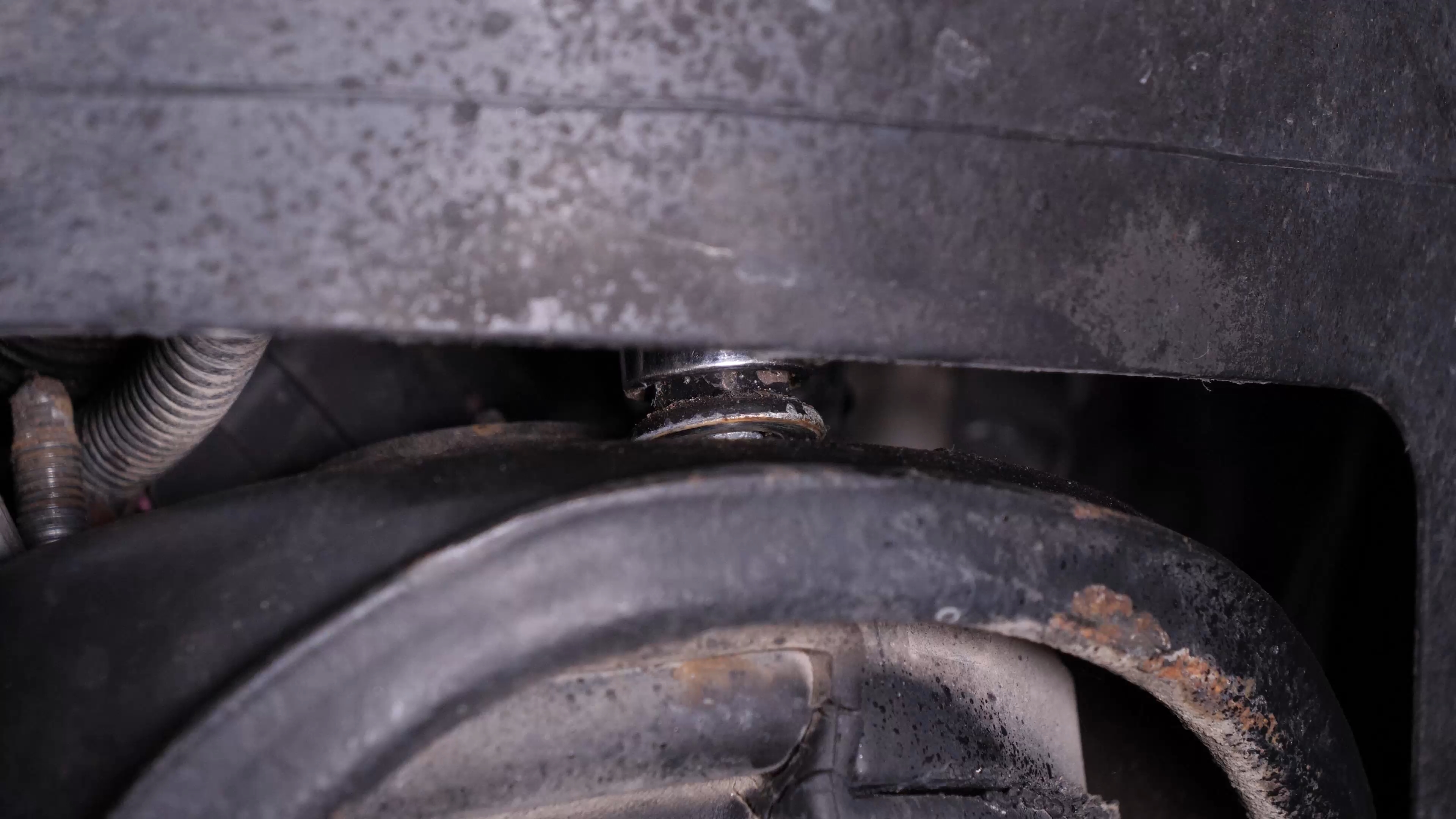 Unscrew the strut mount bearing nuts