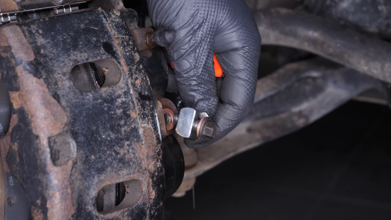 Unscrew the brake hose from the brake caliper