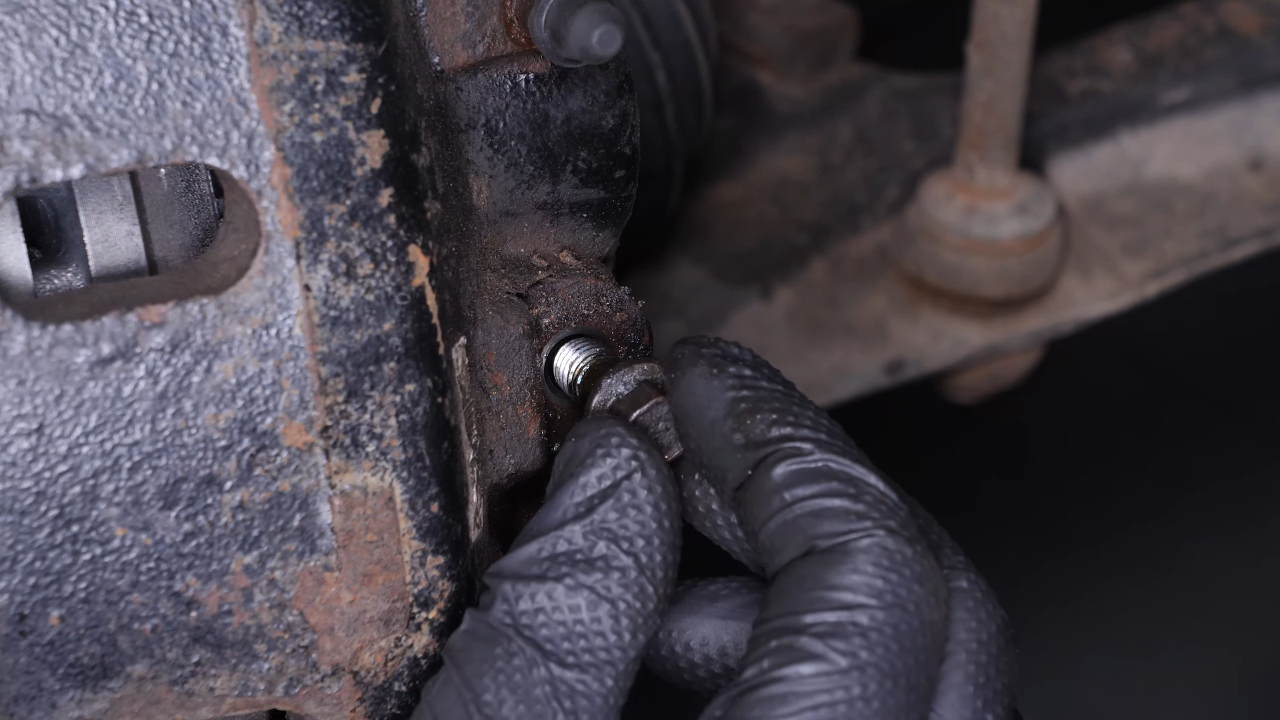 Unscrew the brake hose from the brake caliper