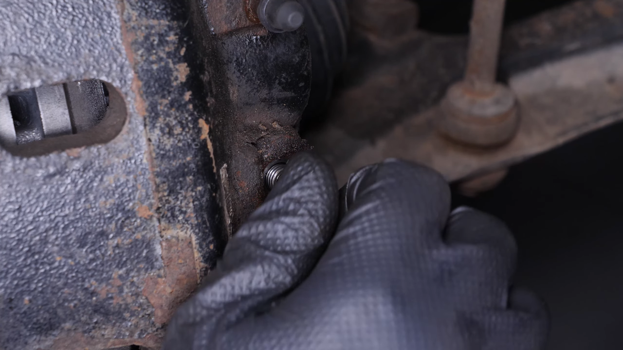 Unscrew the brake hose from the brake caliper
