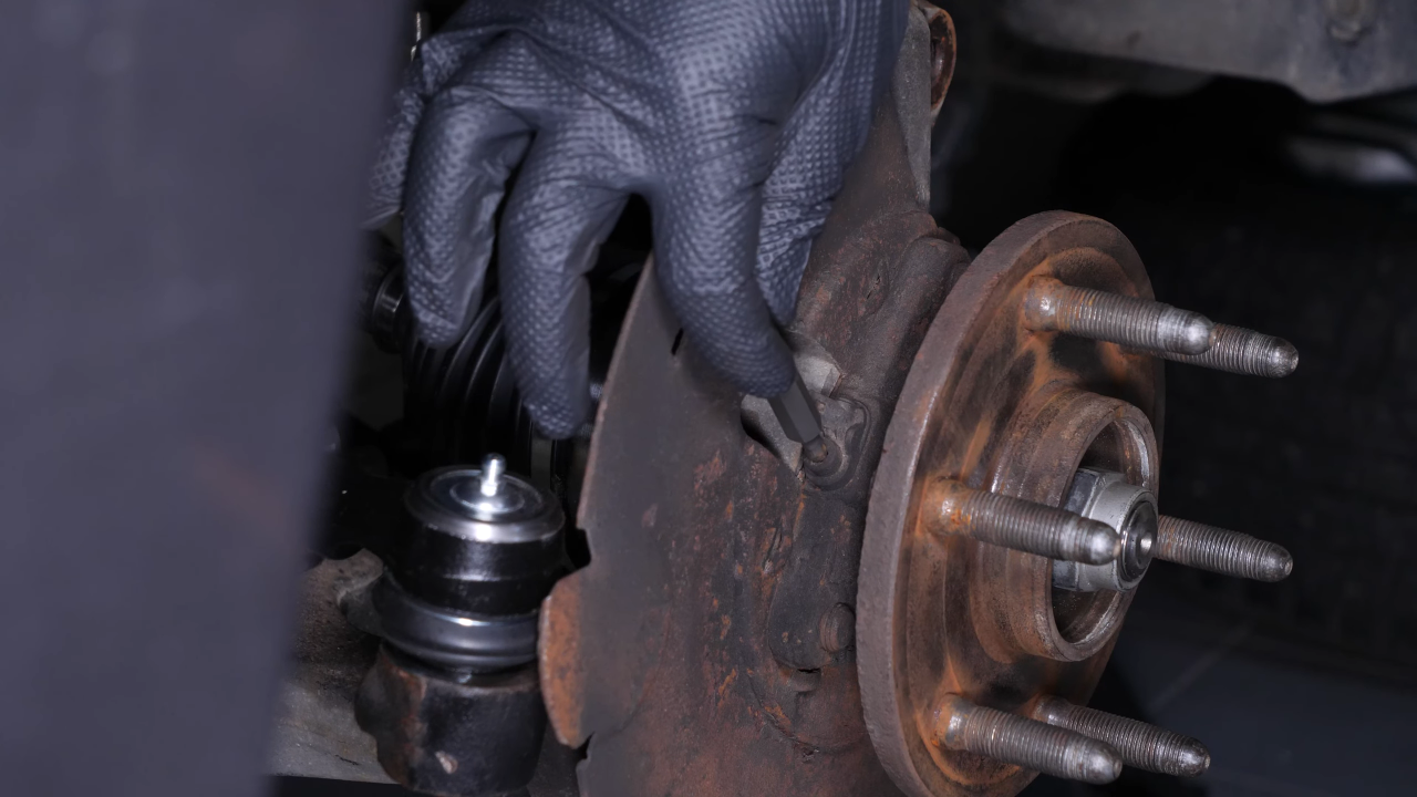 Remove the ABS sensor from the wheel knuckle