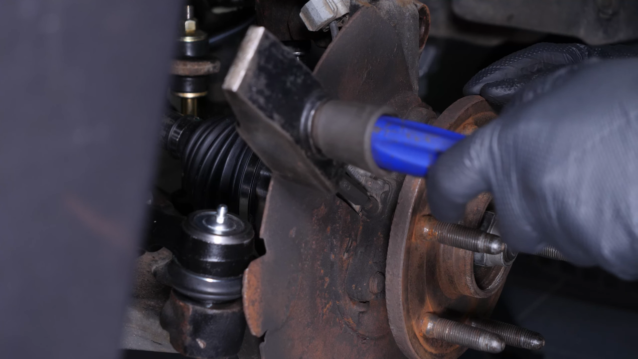 Remove the ABS sensor from the wheel knuckle