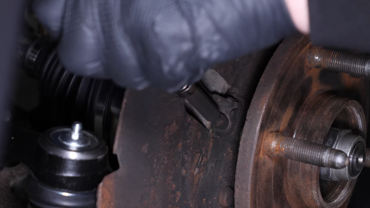 Remove the ABS sensor from the wheel knuckle