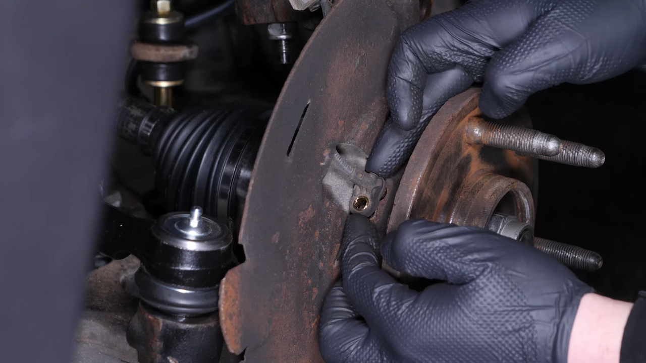 Remove the ABS sensor from the wheel knuckle
