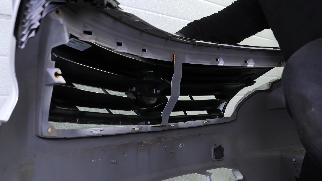 Put the grille assembly back