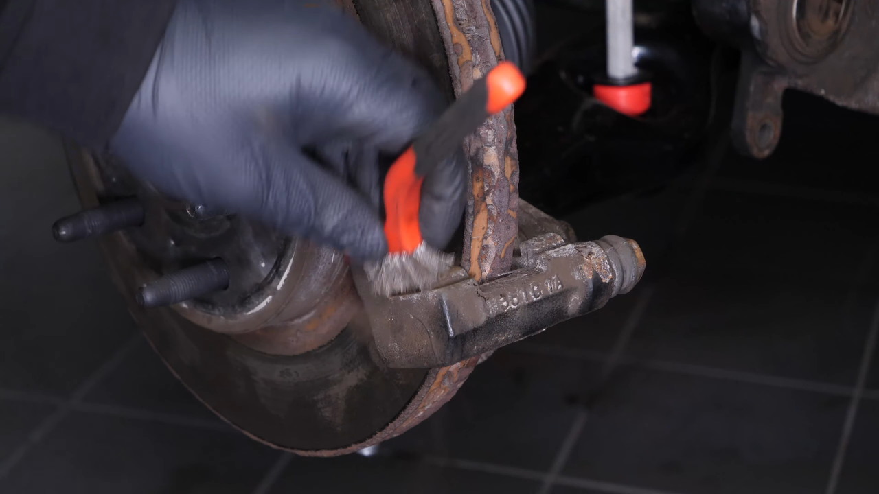 Clean the brake caliper mount