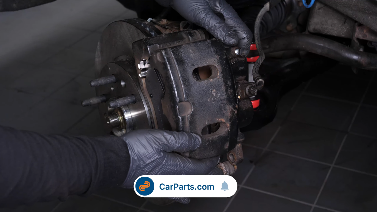 Put the brake caliper back