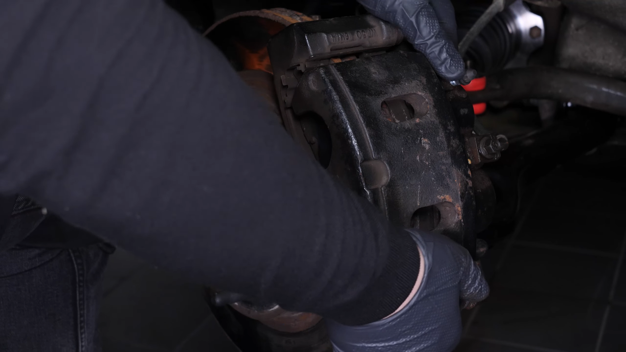 Hang the brake caliper on the strut