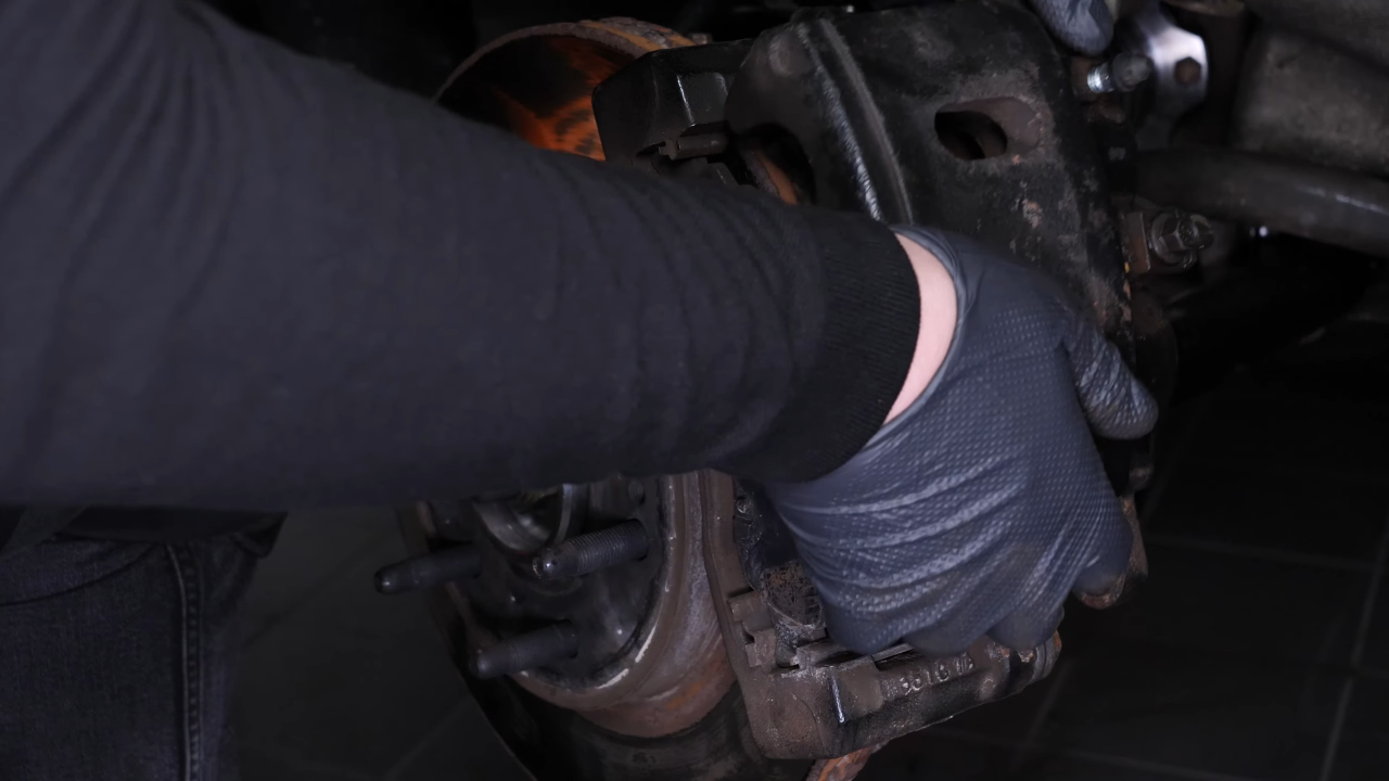 Hang the brake caliper on the strut