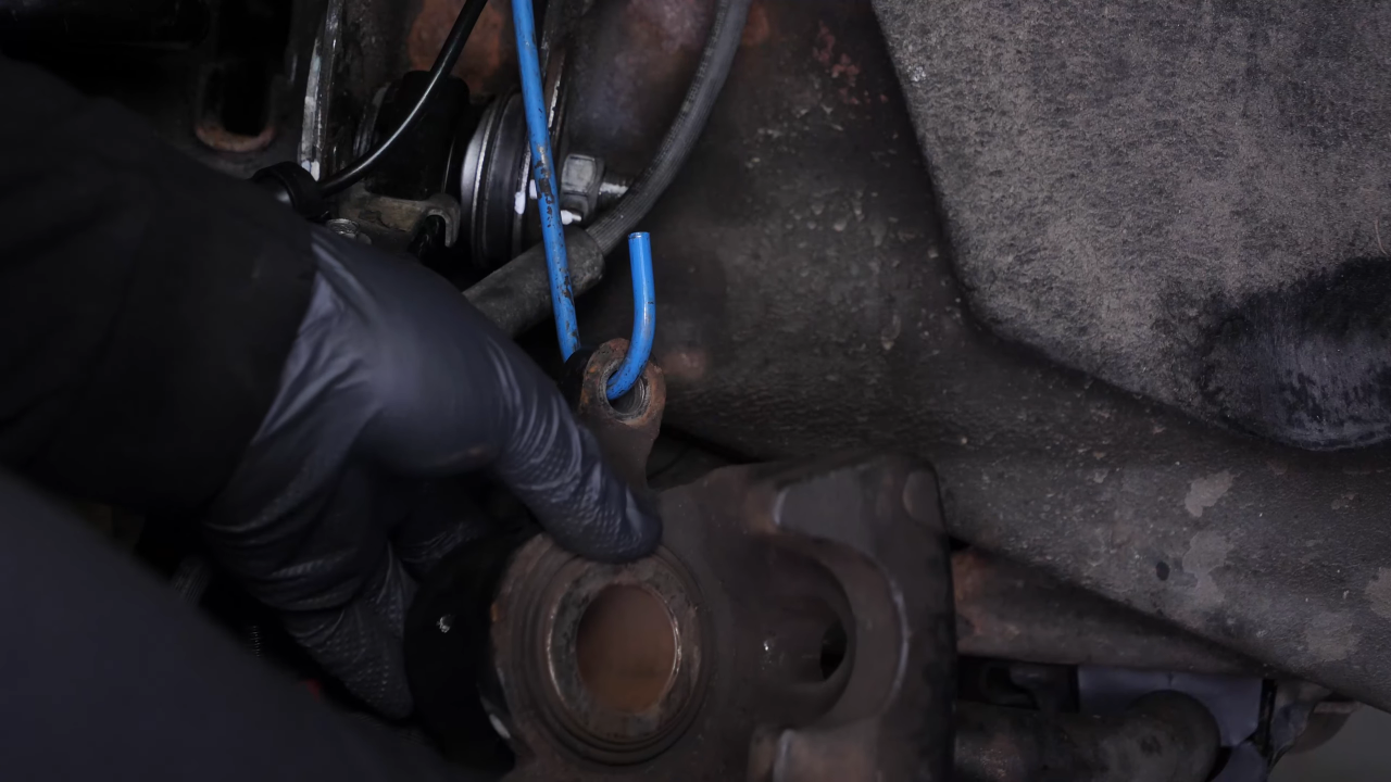 Hang the brake caliper on the strut