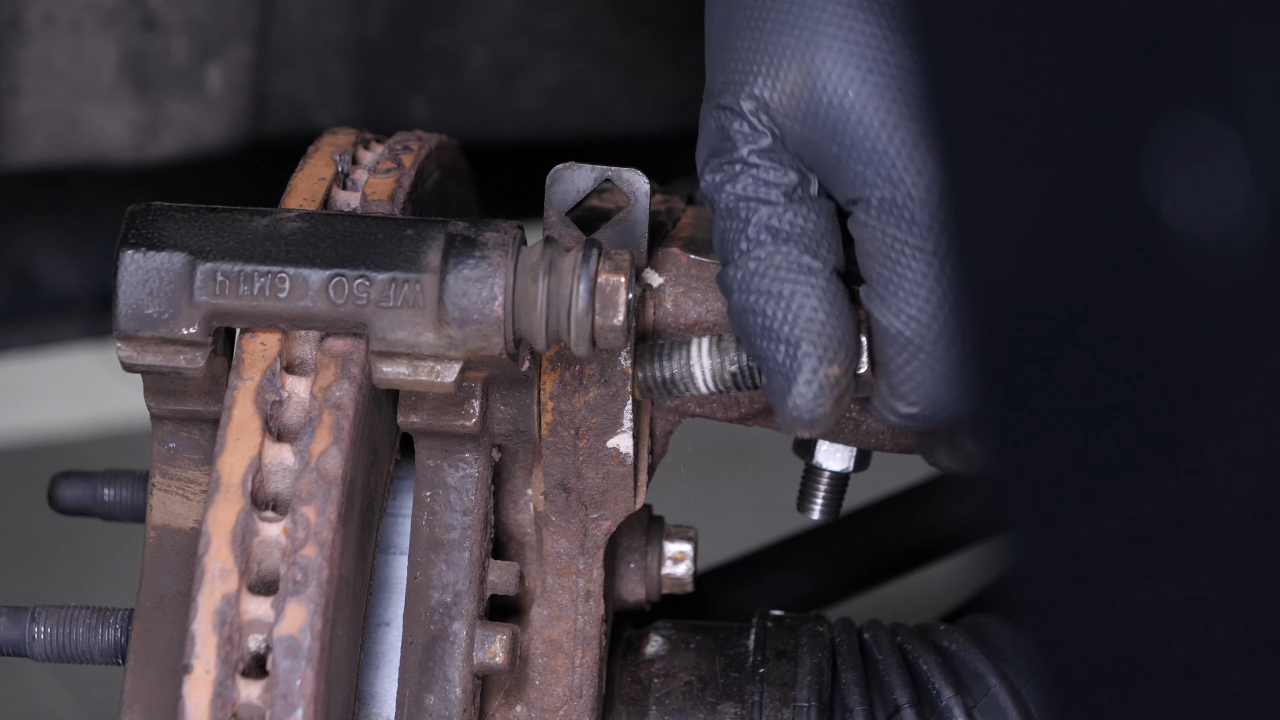 Remove the  brake caliper mount