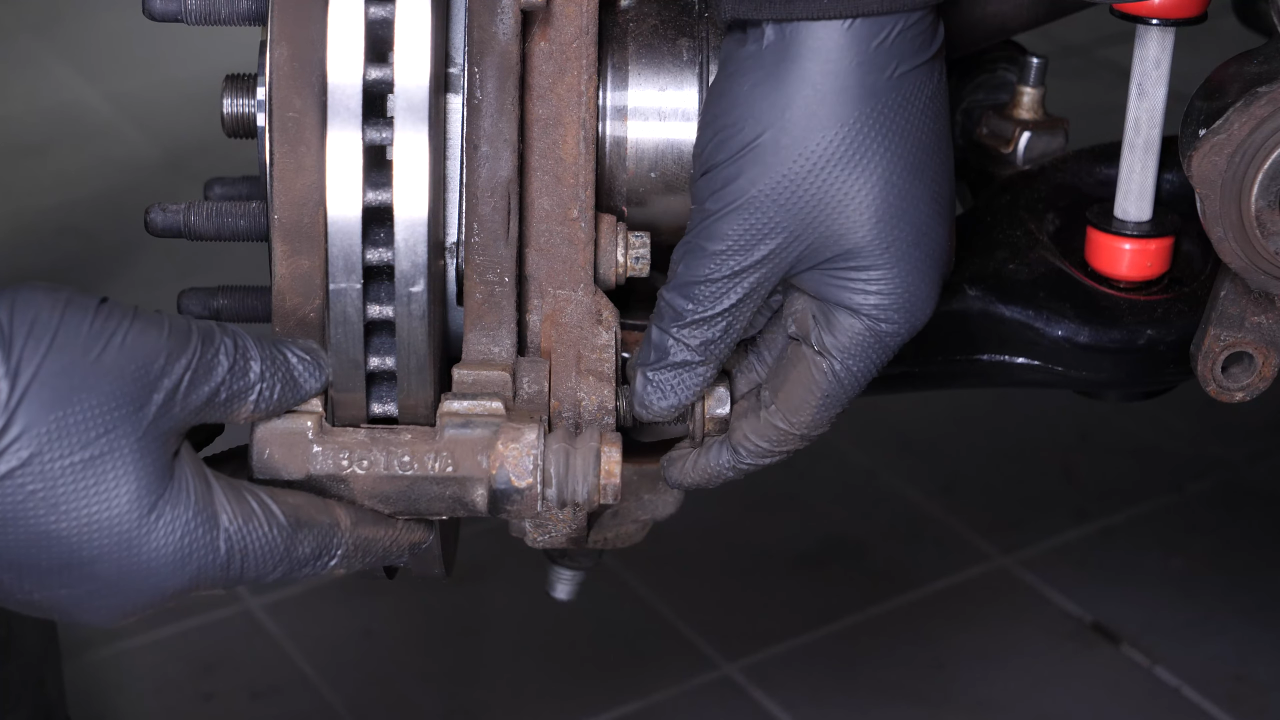 Put the brake caliper mount back on