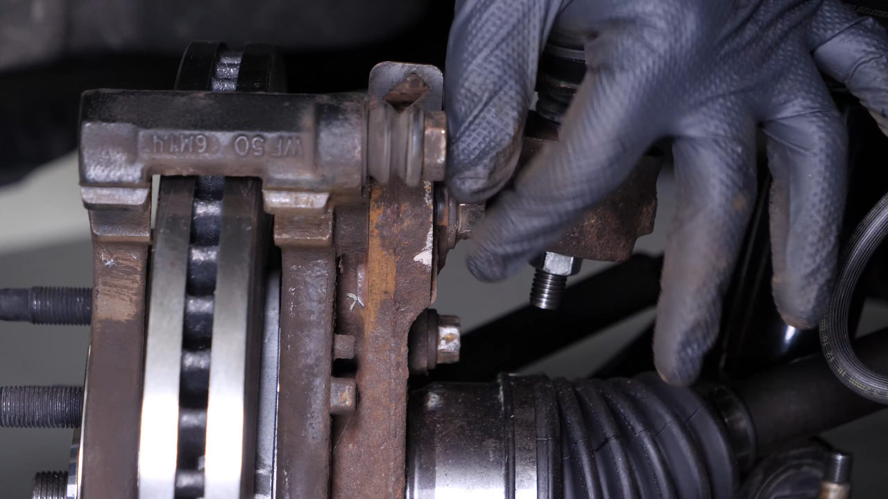 Put the brake caliper mount back on