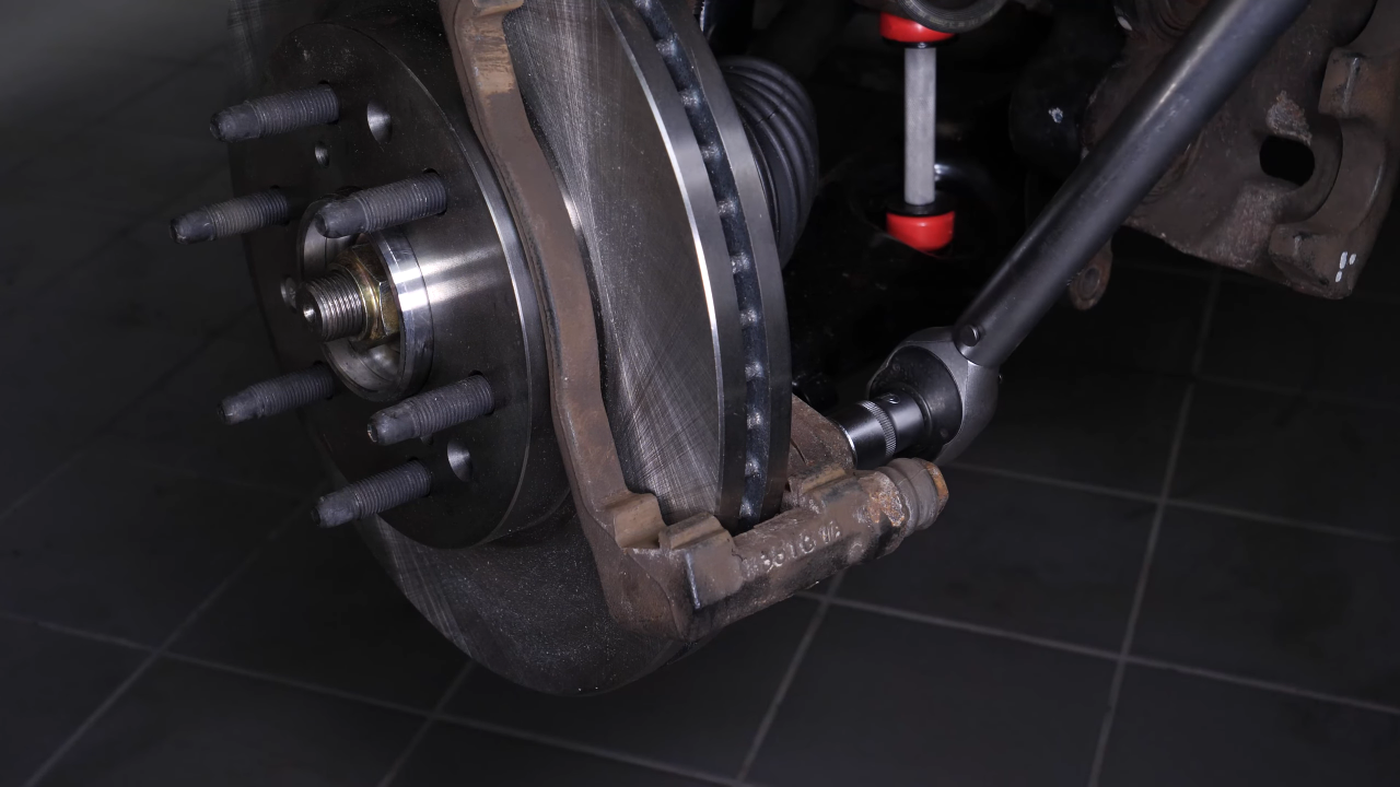 Put the brake caliper mount back on