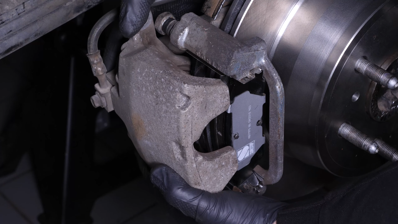 Put the brake caliper back