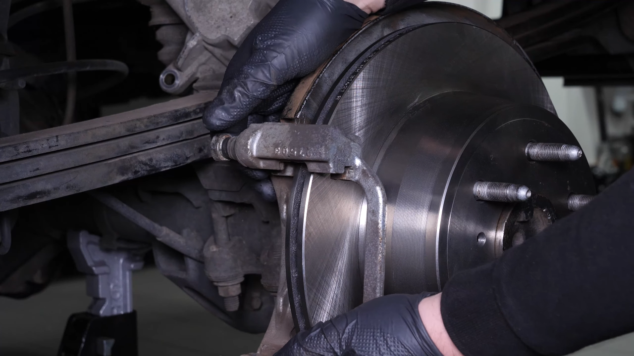 Put the brake caliper mount back on
