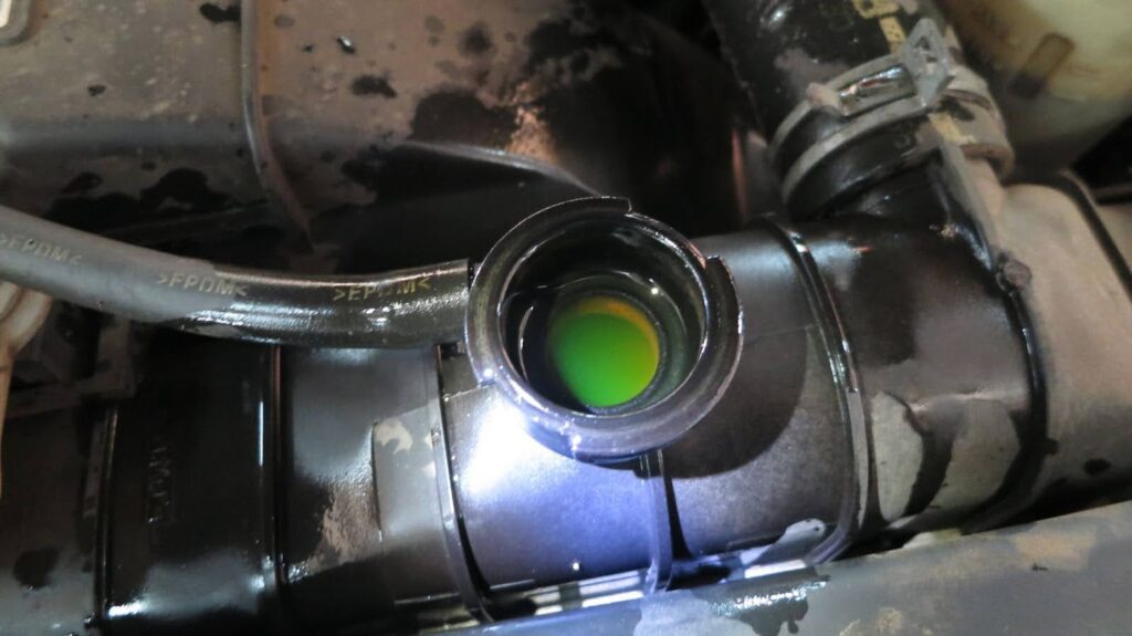 open radiator filler neck with green antifreeze