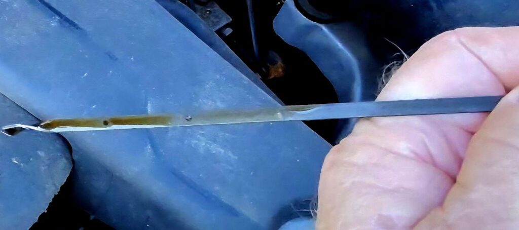 checking engine oil level with dipstick