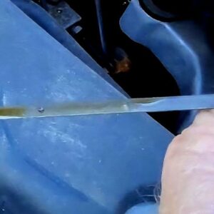 checking engine oil level with dipstick