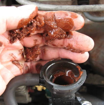 rust colored coolant sludge