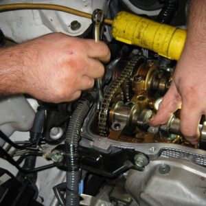 mechanic accessing overhead camshaft