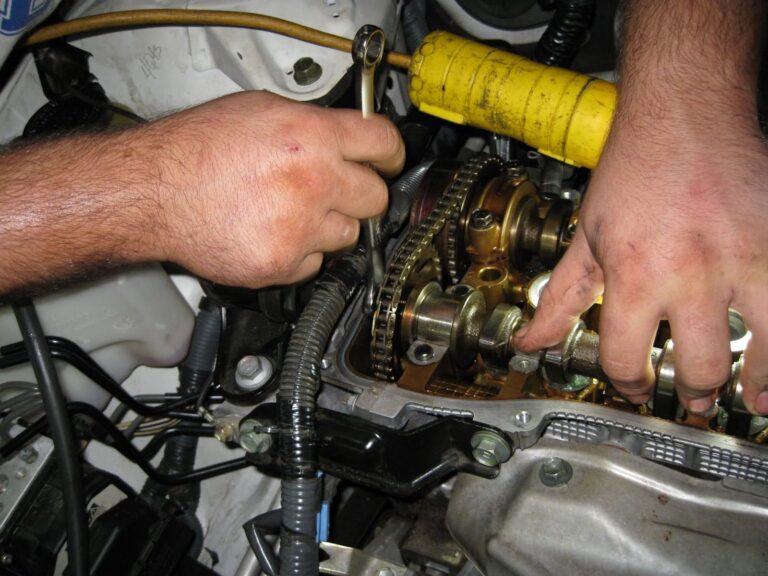 mechanic accessing overhead camshaft