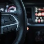 man putting on a steering wheel cover
