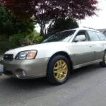 man parking his subaru outback ll bean edition