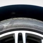 man reading the details on his tire