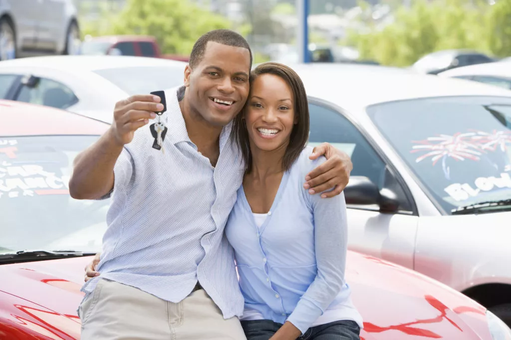 couple spending their tax refund to purchase a used car