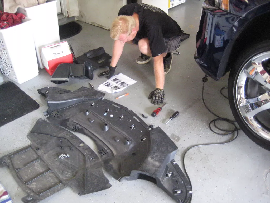 Disassembly requires removing both pans in the front of the vehicle