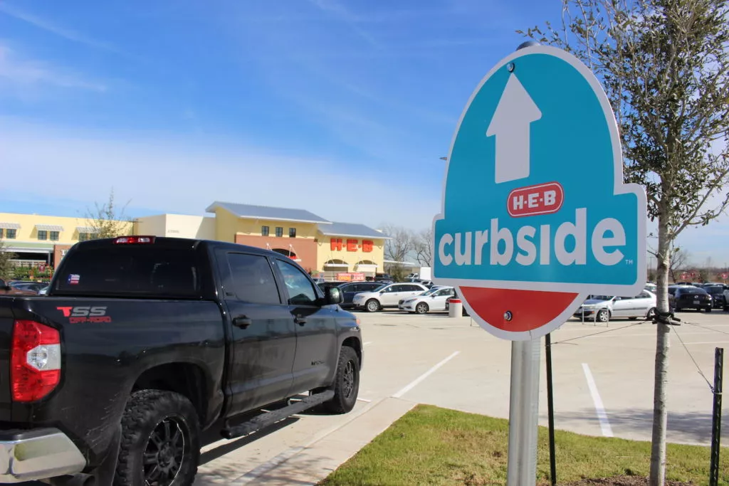 truck stopping at HEB curbside pickup sign