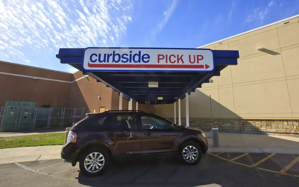 SUV stopping at a Meijer curbside pickup spot