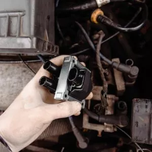 man replacing ignition coil