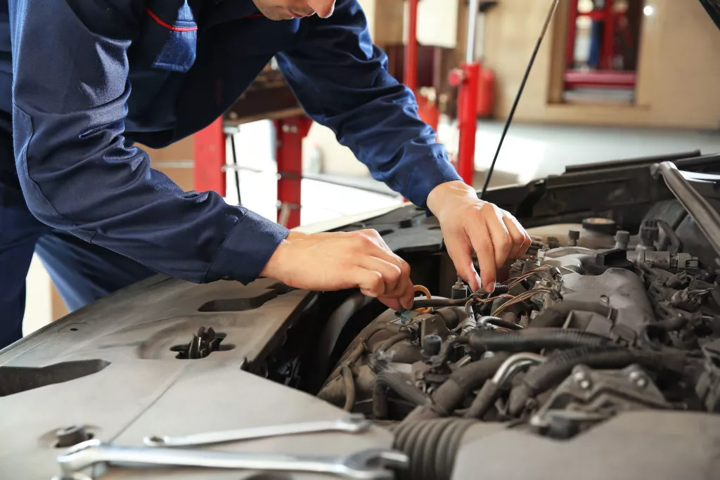 mechanic checking car hood