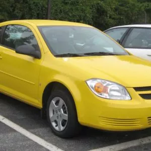 yellow chevrolet cobalt in parking lot