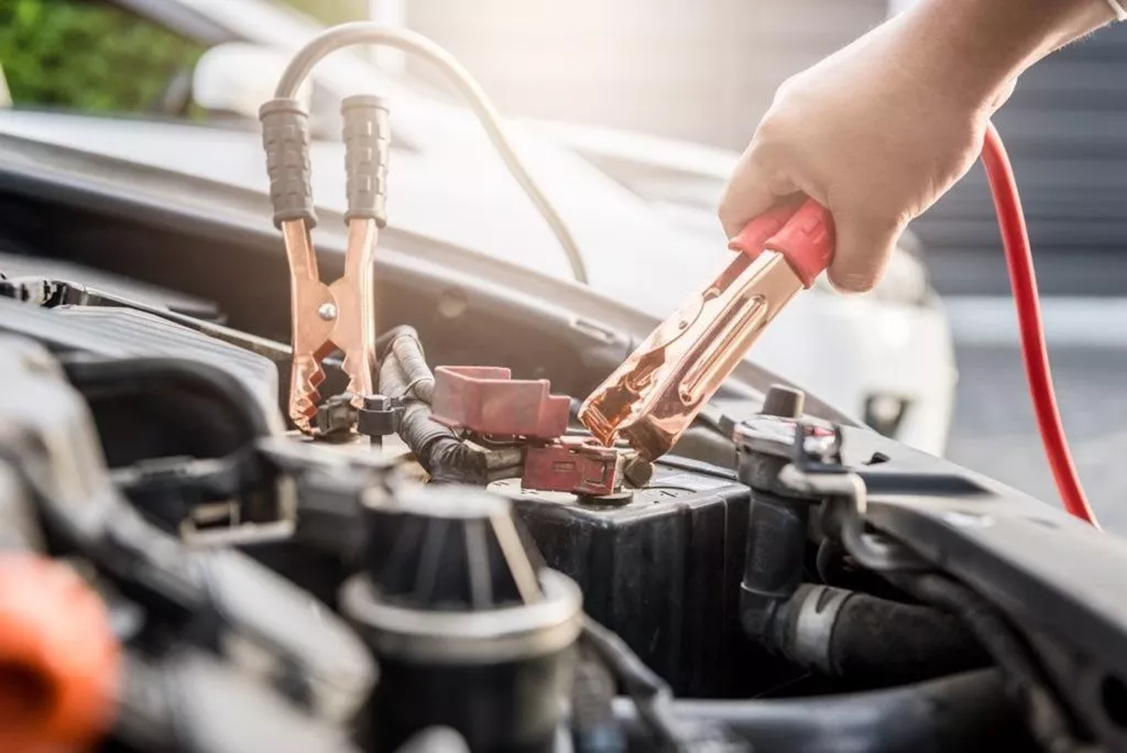 man jump starting his car