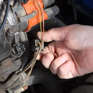 mehanic holding coolant temperature sensor