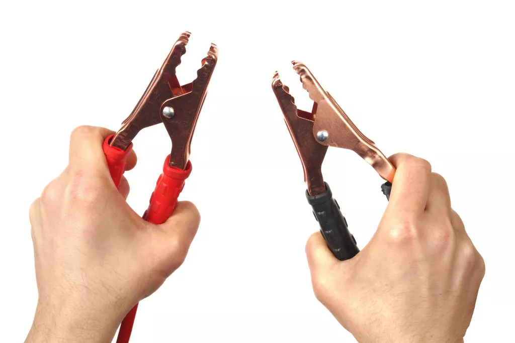 touching jumper cables together