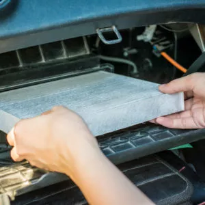 mechanic replacing cabin air filter
