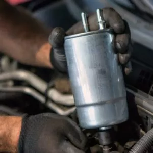 mechanic holding fuel filter