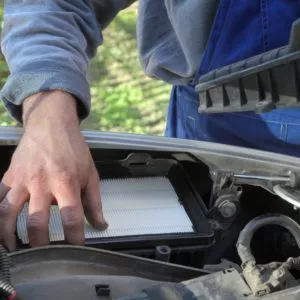 mechanic installing new air filter