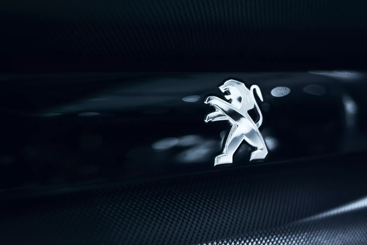silver peugeot logo on black background