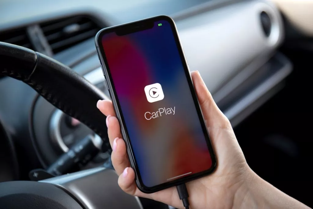 driver holding iphone with carplay cable issue