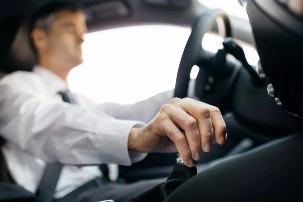 Businessman hand shifting the gear stick