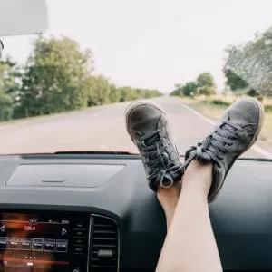 Feet on top of a cars dashboard