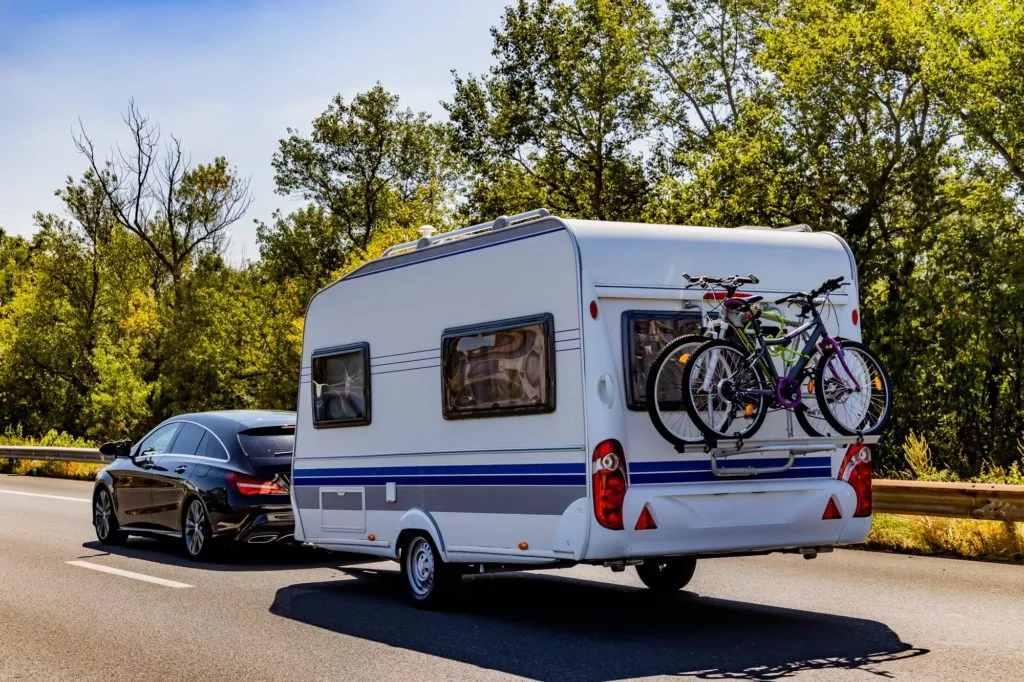 car with caravan trailer on a freeway road