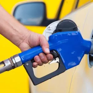 man refuelling car gas tank